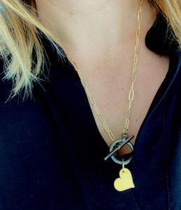 Gold chain with black metalic clasp and heart necklace